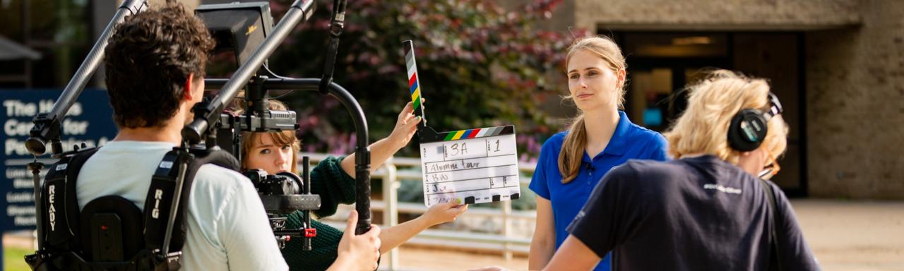 Behind the seats of a video shoot as a student speaks directly to camera